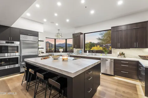 a kitchen with counter top space a sink stainless steel appliances and cabinets