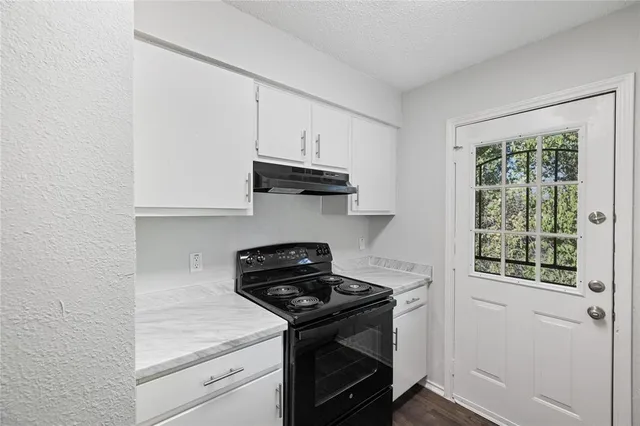 a kitchen with a stove and a microwave