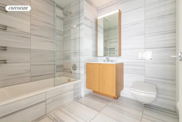 a bedroom with a large bed and a potted plant