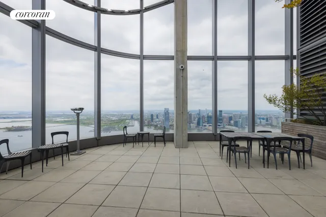 a living room with furniture and a floor to ceiling window