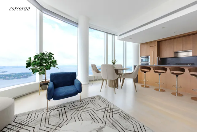 a living room with furniture potted plant and a large window