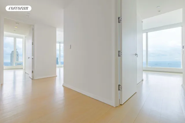 a view of a kitchen with wooden floor and a large window