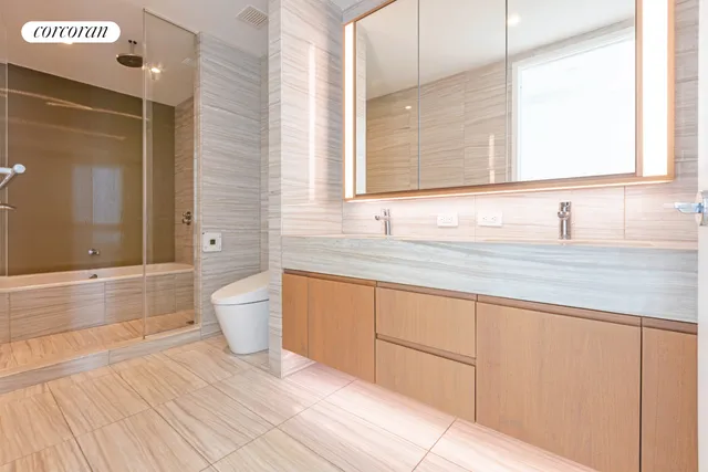 a bedroom with a bed a mirror and a large window