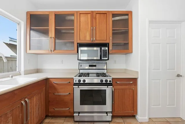 a kitchen with stainless steel appliances a stove and a sink