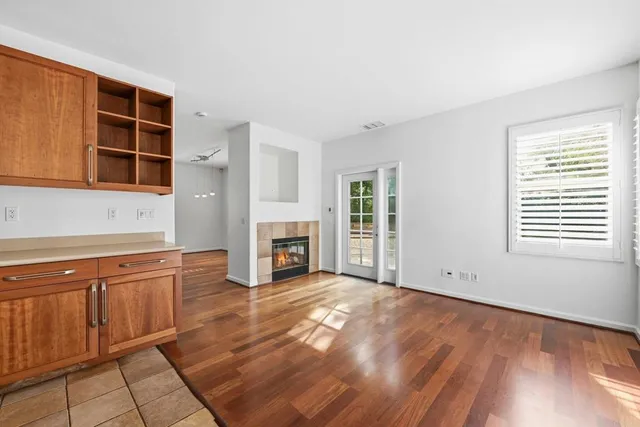 a view of an empty room with a fireplace and a window