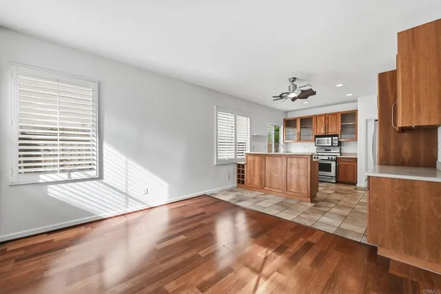 a view of a kitchen with a sink dishwasher cabinets and wooden floor