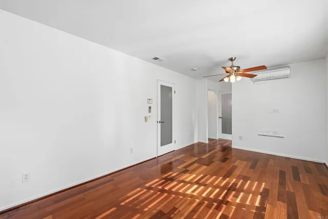 a view of a room with wooden floor