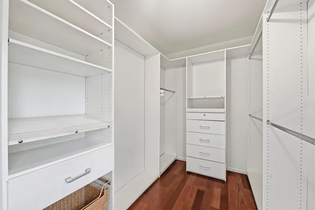 a view of walk in closet with empty racks