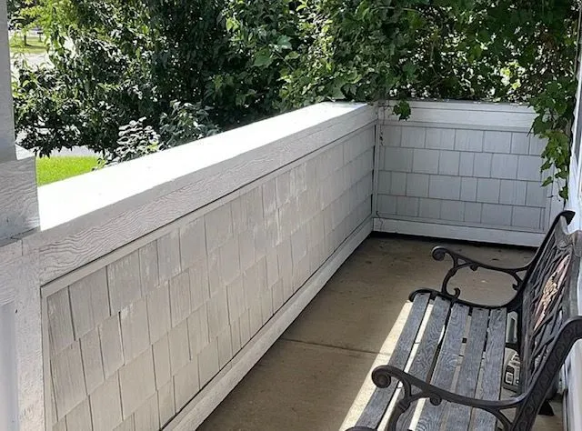 a view of a roof deck with wooden floor and fence