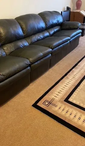 a bed sitting in a room next to a lamp