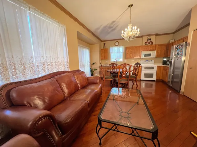 a kitchen with stainless steel appliances a sink cabinets and wooden floor