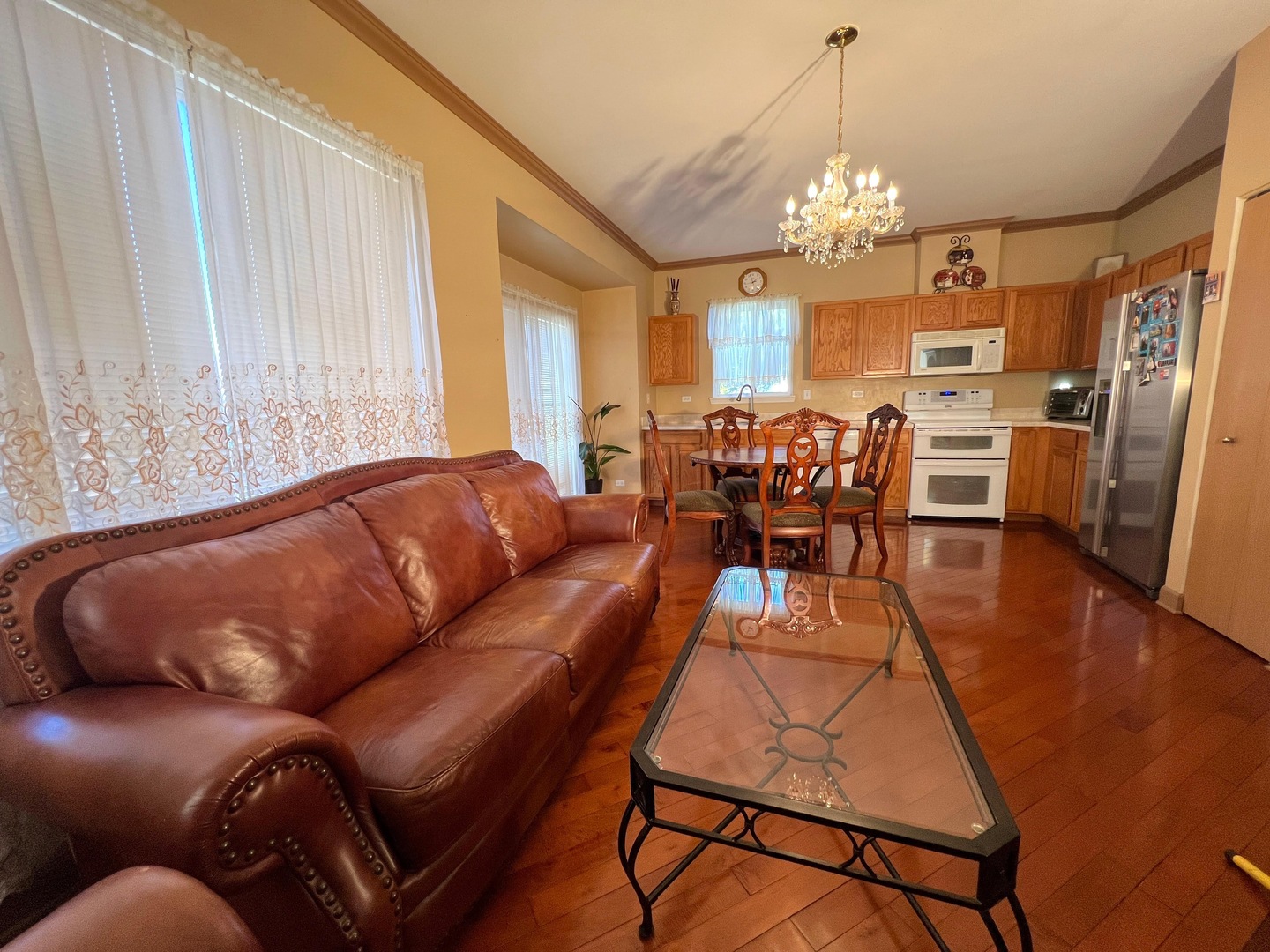 752 South Parkside Drive Round Lake, IL 60073 - Photo 25 of 38 a living room with furniture a dining table and a chandelier