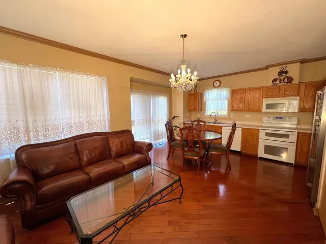 a kitchen with stainless steel appliances granite countertop a sink refrigerator and cabinets
