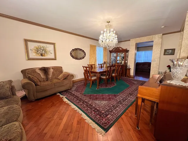a living room with furniture and a chandelier
