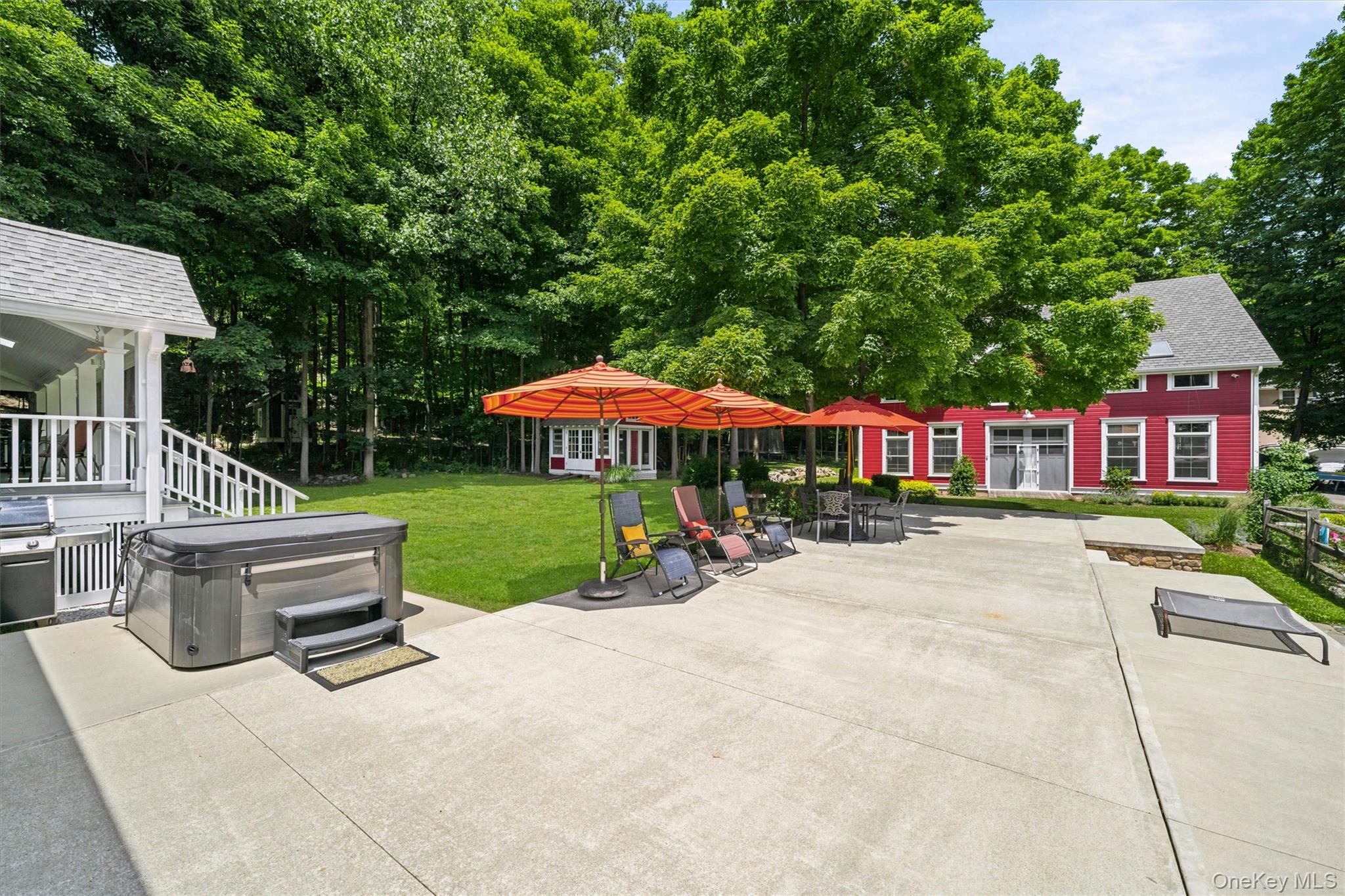 324 Haverstraw Road Suffern, NY 10901 - Photo 35 of 50 a view of a patio with a table and chairs under an umbrella