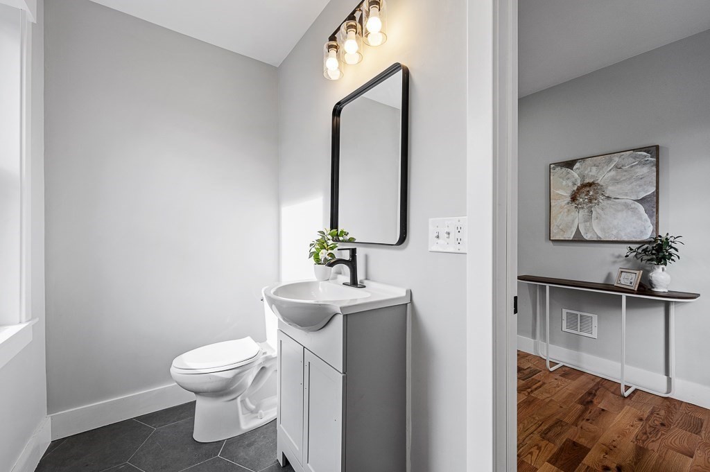 108 Paxton Road Spencer, MA 01562 - Photo 12 of 26 a bathroom with a toilet sink and mirror