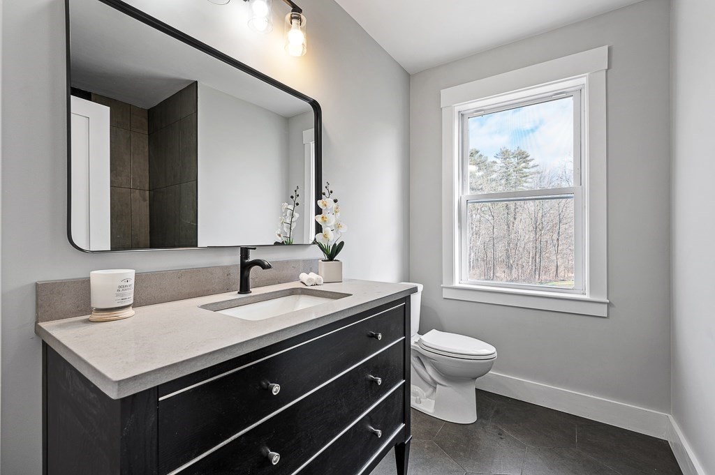 108 Paxton Road Spencer, MA 01562 - Photo 18 of 26 a bathroom with a toilet sink and mirror