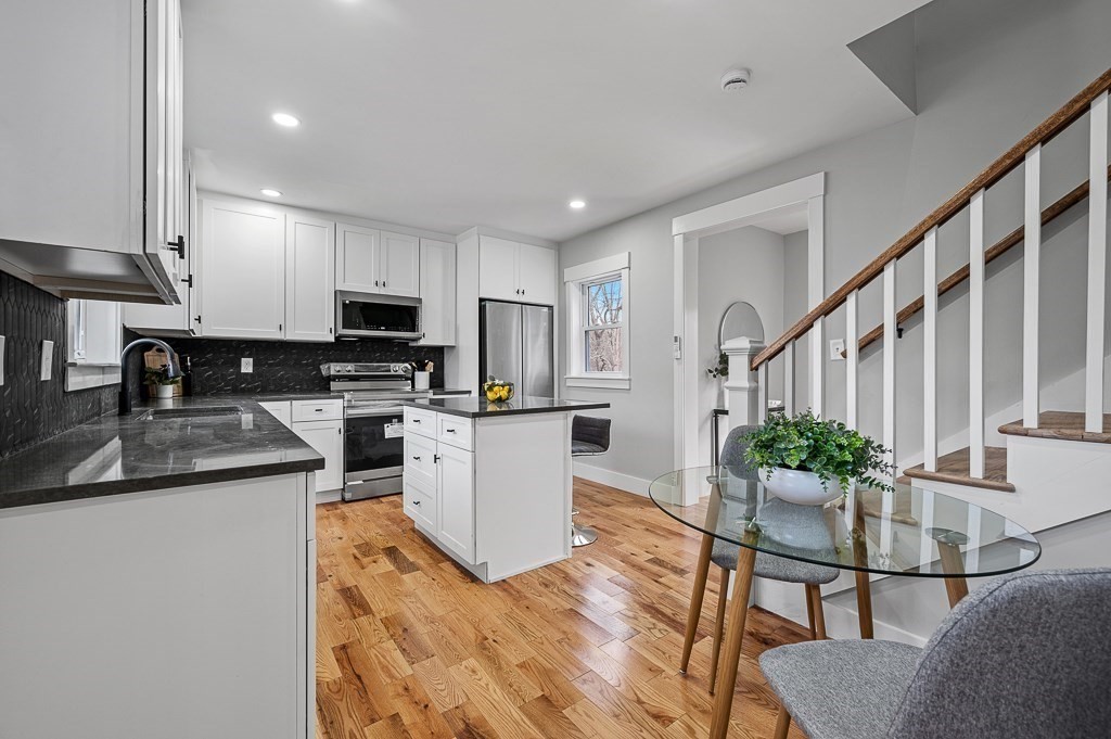 108 Paxton Road Spencer, MA 01562 - Photo 8 of 26 a kitchen with granite countertop white cabinets and stainless steel appliances