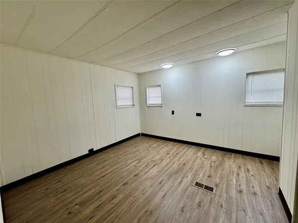 a view of a room with wooden floor and white doors