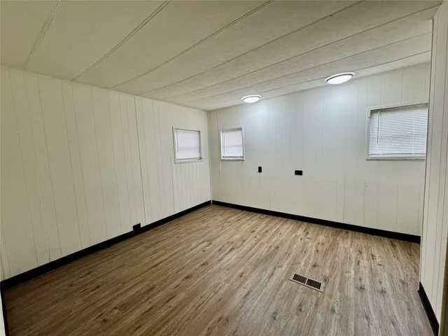 a view of a room with wooden floor and white doors