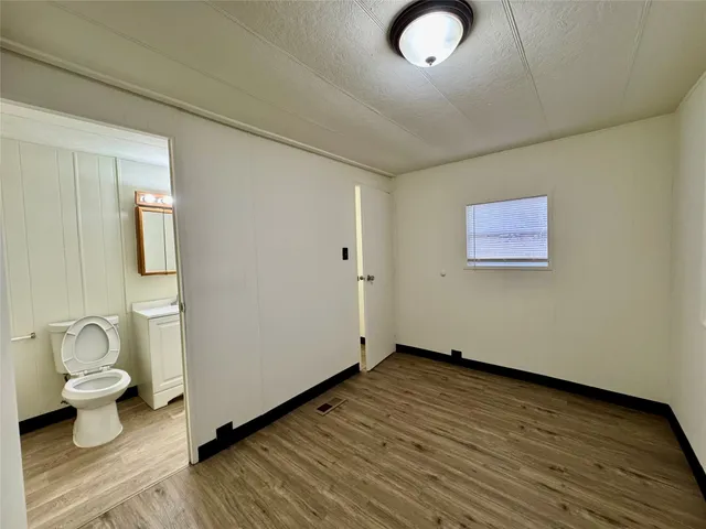 a bathroom with a sink a toilet a mirror and bathtub