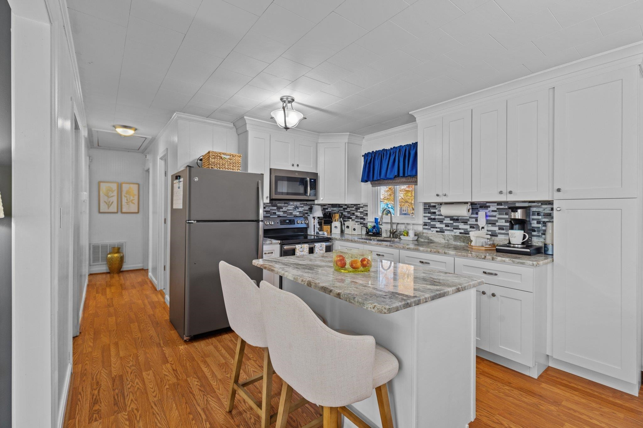 761 Jones Lester Road Roxboro, NC 27574 - Photo 12 of 27 a kitchen with stainless steel appliances granite countertop a refrigerator a sink a stove a dining table and chairs