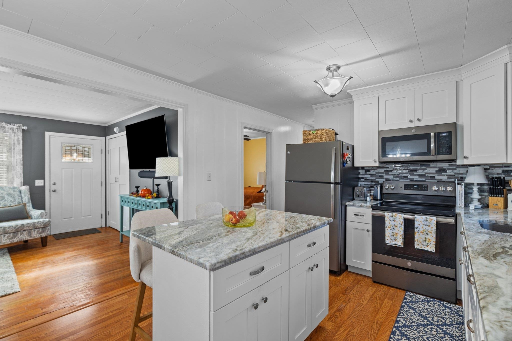 761 Jones Lester Road Roxboro, NC 27574 - Photo 14 of 27 a kitchen with granite countertop a refrigerator a stove a microwave oven a sink dishwasher with a dining table and chairs