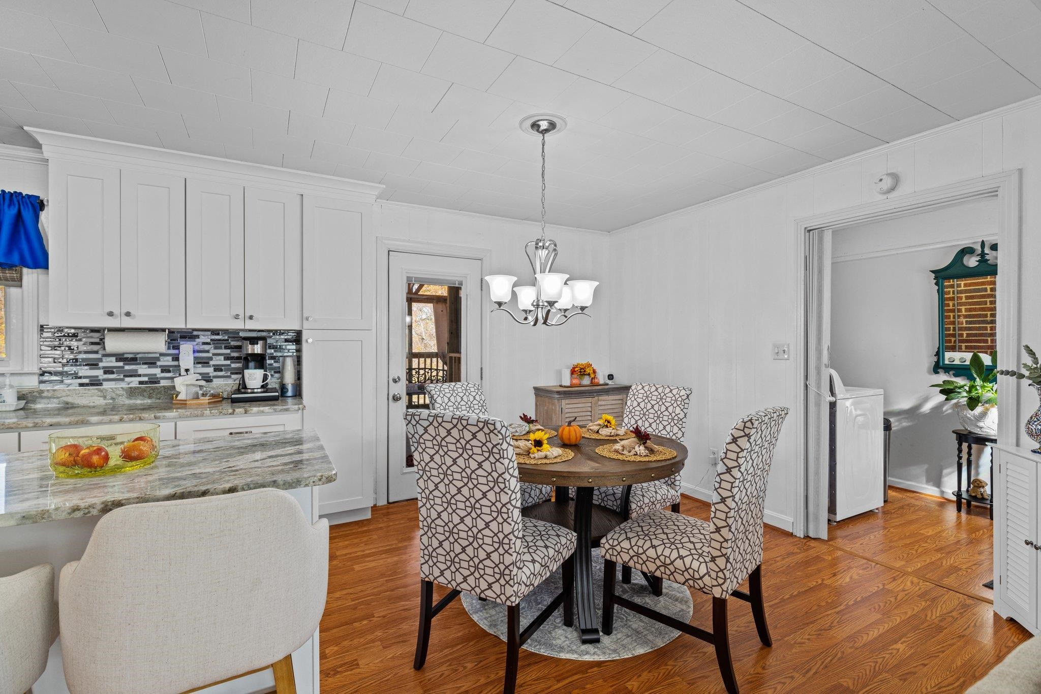 761 Jones Lester Road Roxboro, NC 27574 - Photo 17 of 27 a dining room with furniture a chandelier and wooden floor