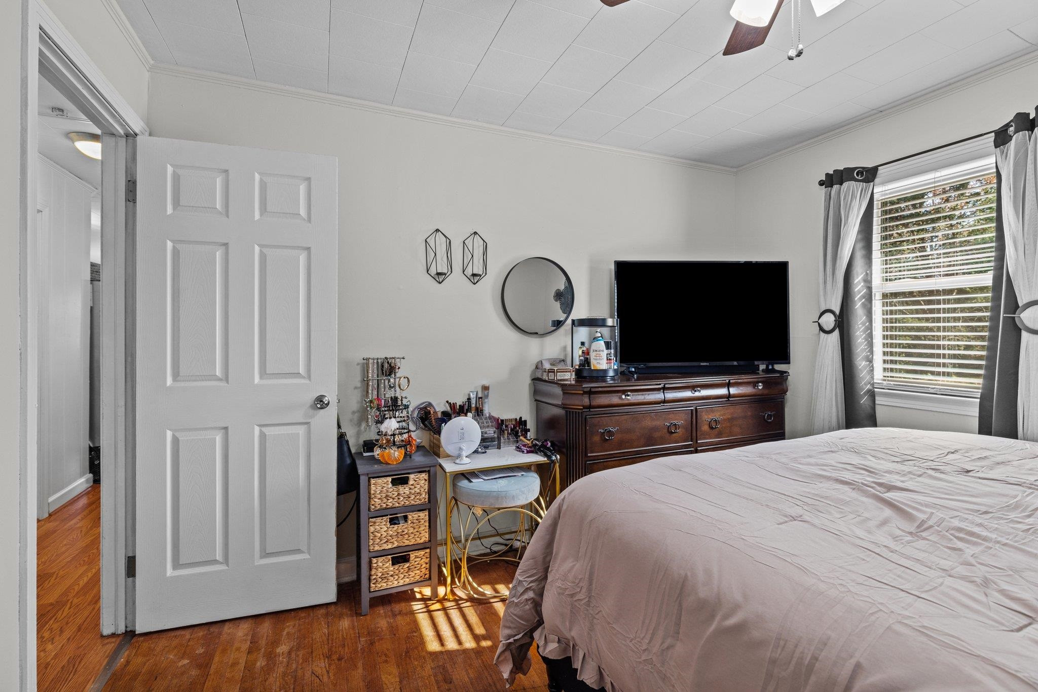 761 Jones Lester Road Roxboro, NC 27574 - Photo 20 of 27 a bedroom with bed and a flat tv screen on dresser