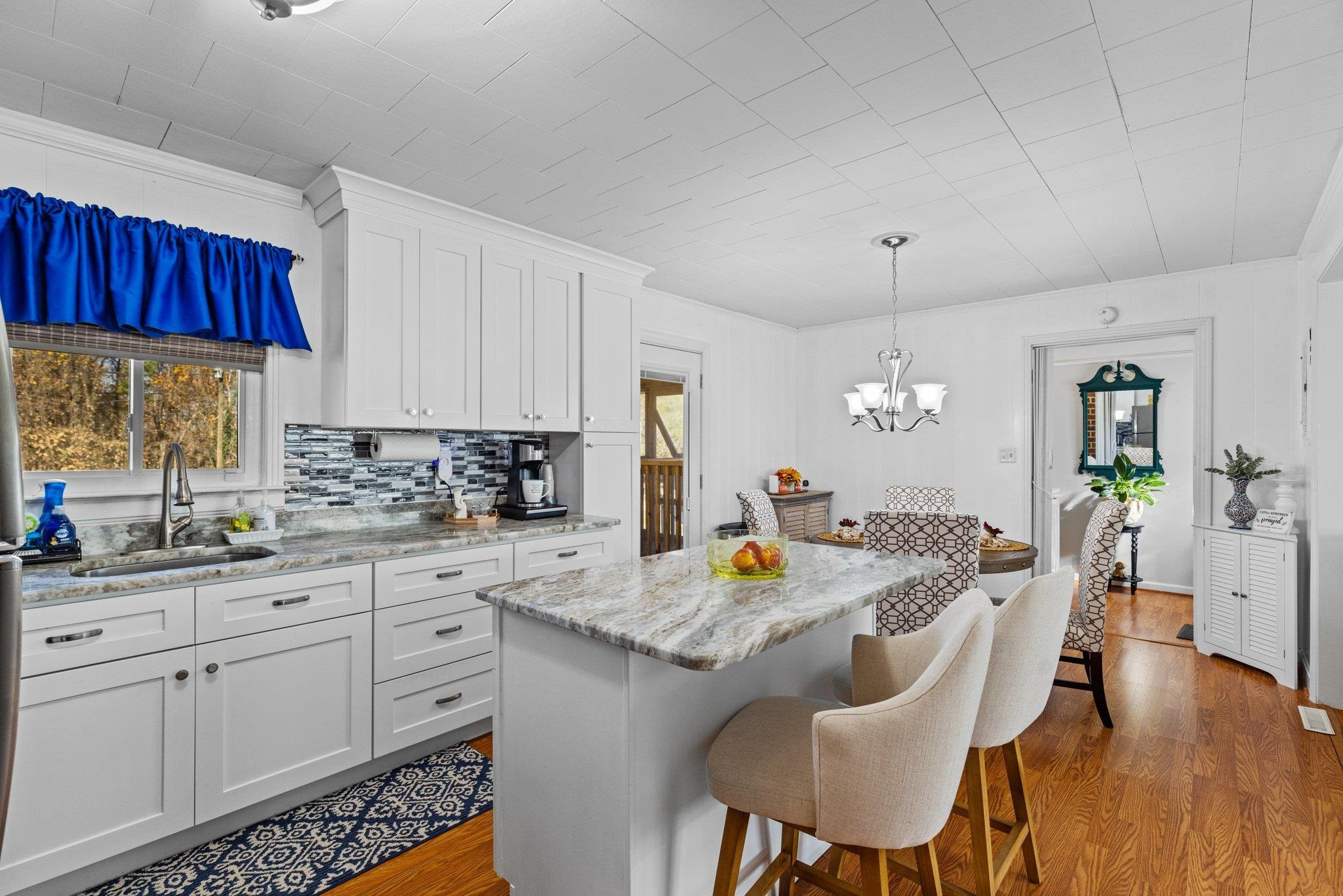 761 Jones Lester Road Roxboro, NC 27574 - Photo 10 of 27 a kitchen with stainless steel appliances granite countertop a table chairs and a refrigerator