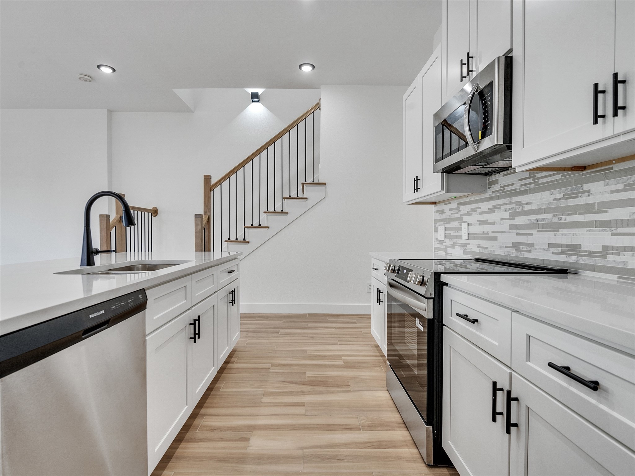 4421 Reed Road, Unit A AND B Houston, TX 77051 - Photo 11 of 39 a kitchen with granite countertop white cabinets stainless steel appliances and a sink