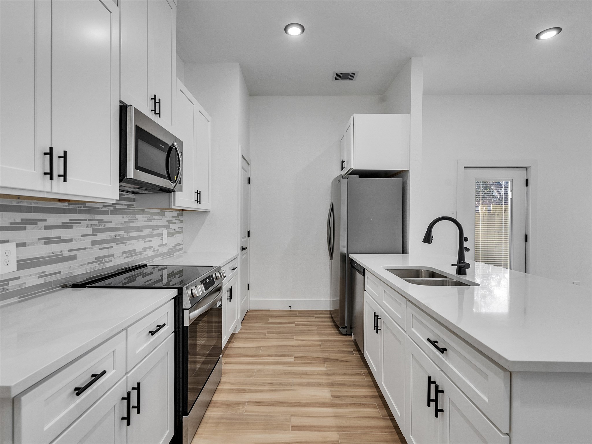 4421 Reed Road, Unit A AND B Houston, TX 77051 - Photo 8 of 39 a kitchen with stainless steel appliances granite countertop a stove and a sink