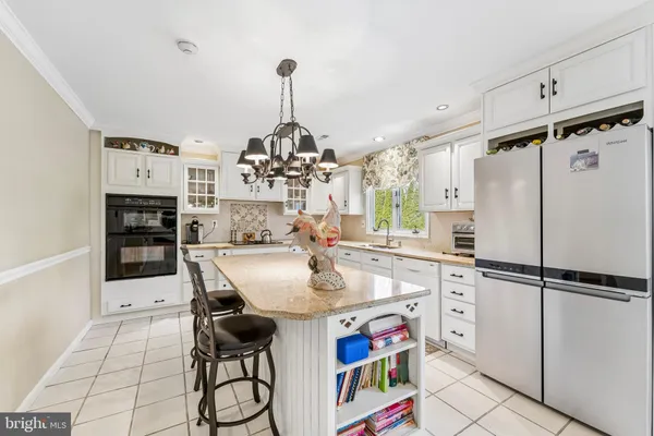 a kitchen with stainless steel appliances a stove a refrigerator and a center island