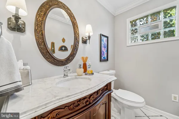 a bathroom with a toilet a sink and a mirror
