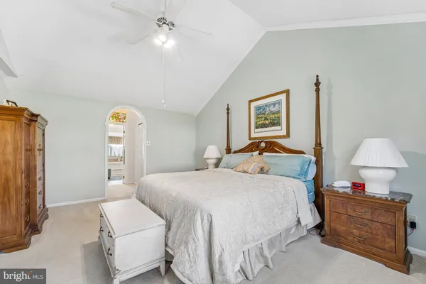 a bedroom with a bed and flat screen tv