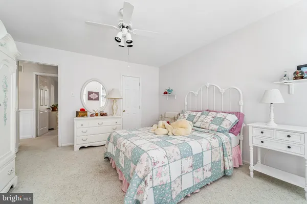 a bedroom with a bed and ceiling fan