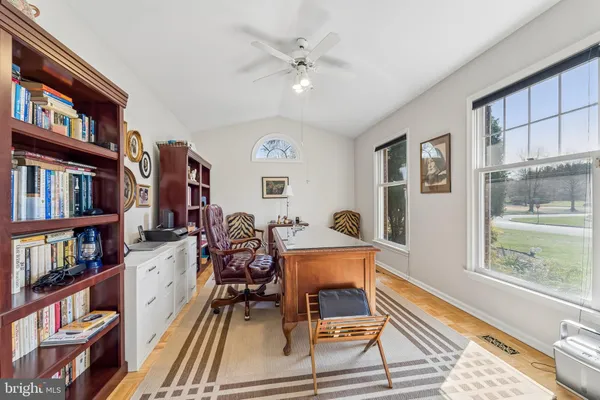 a living room with lots of books and a book shelf