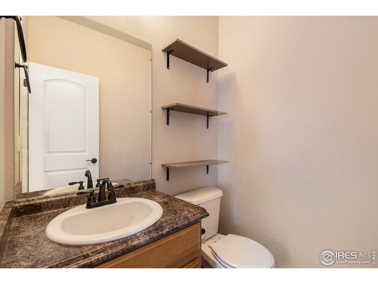 8524 15th St Road Greeley, CO 80634 - Photo 8 of 29 Half-bath off kitchen/garage entrance.