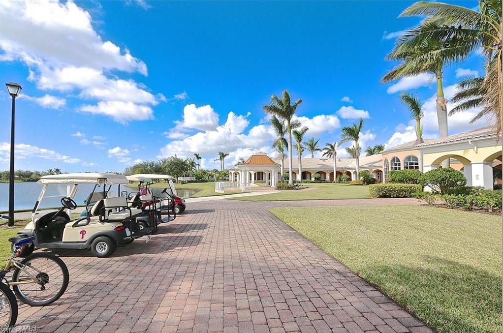 5477 Freeport Lane Naples, FL 34119 - Photo 33 of 36 a view of a patio with table and chairs under an umbrella