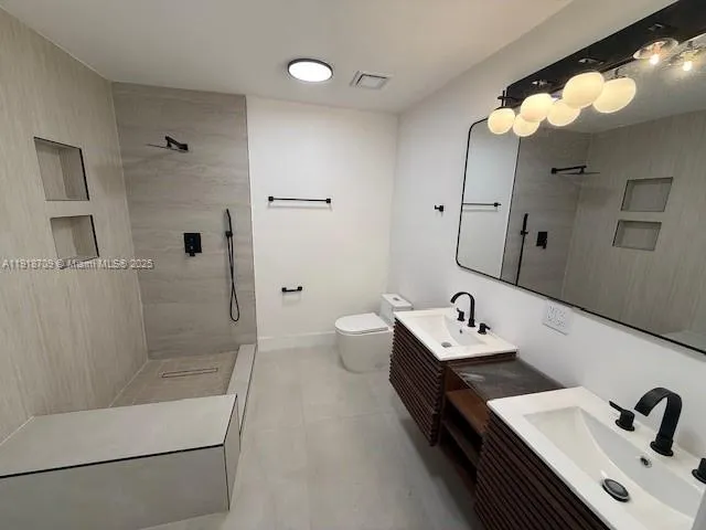 a bathroom with a tub sink mirror and toilet