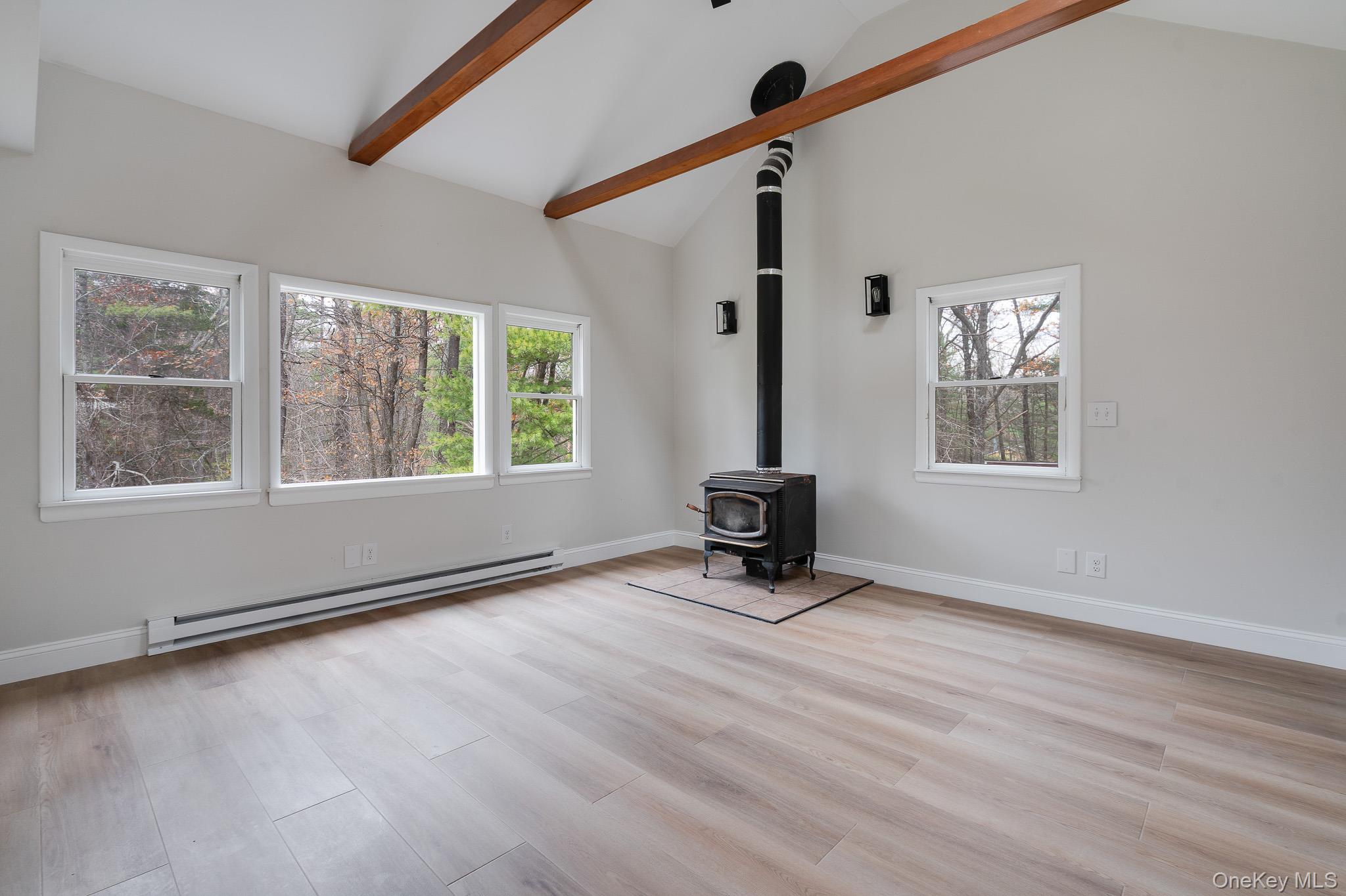 356 Sands Road Middletown, NY 10941 - Photo 12 of 22 a view of an empty room with a window and wooden floor