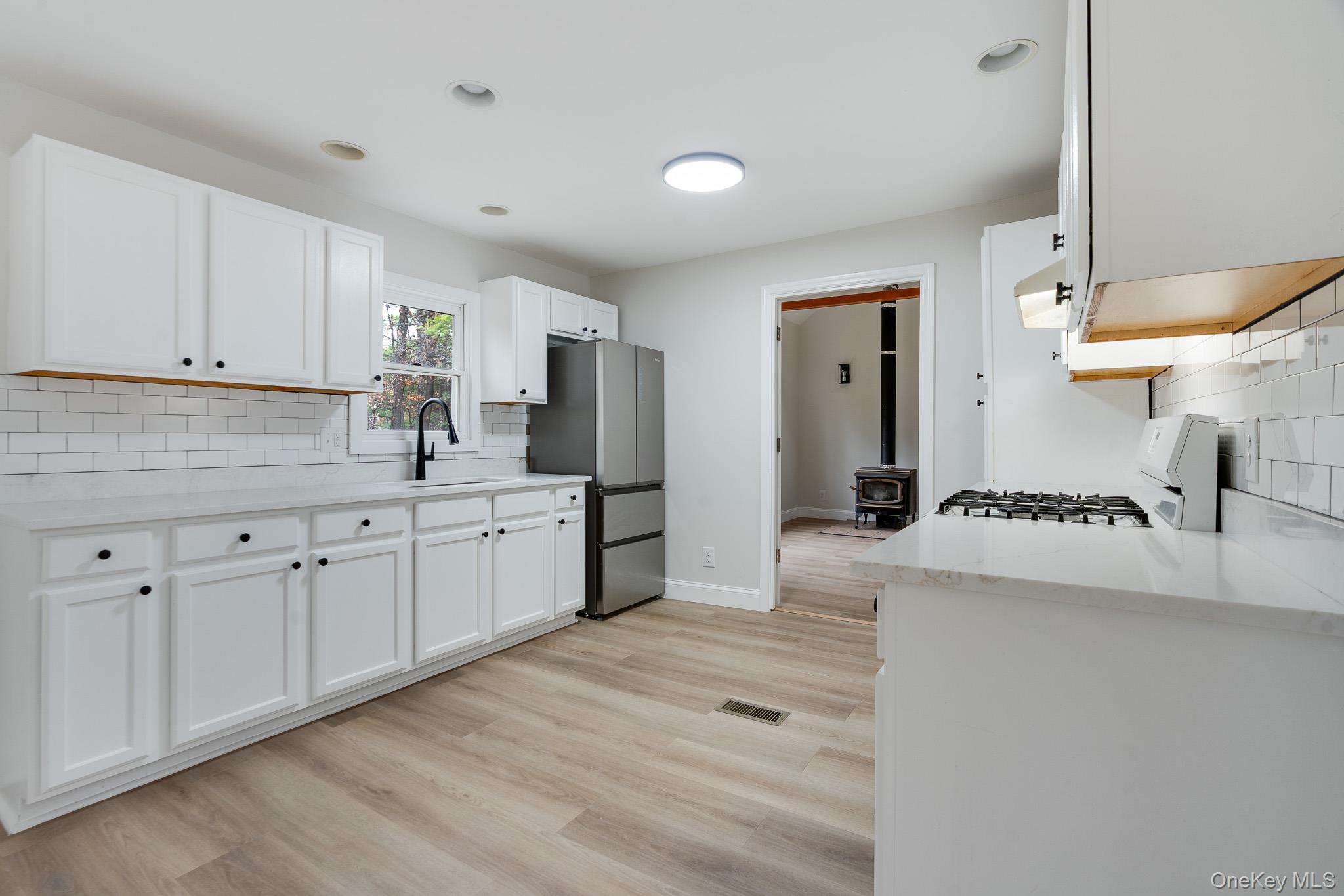 356 Sands Road Middletown, NY 10941 - Photo 8 of 22 a kitchen with white cabinets and sink