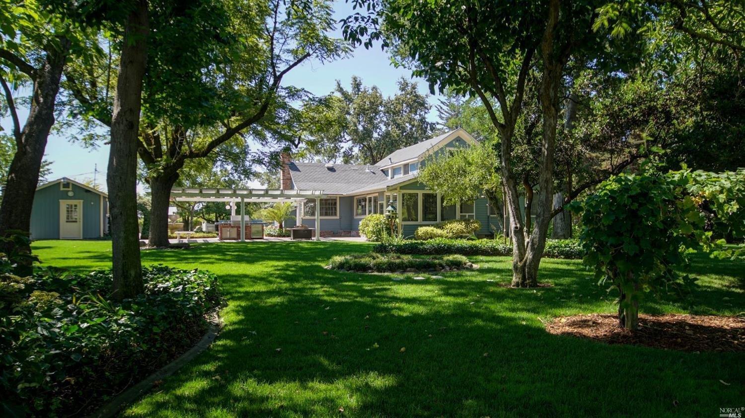 1864 Willowside Road Santa Rosa, CA 95401 - Photo 1 of 1 a view of a house with a big yard potted plants and large tree