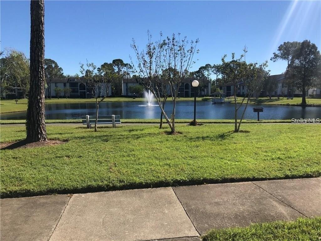 8215 Sun Spring Circle, Unit 63 Orlando, FL 32825 - Photo 21 of 22 a view of a swimming pool with a yard