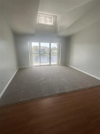 an empty room with a empty space and windows