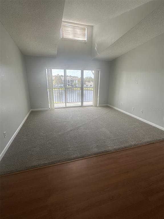 8215 Sun Spring Circle, Unit 63 Orlando, FL 32825 - Photo 4 of 22 an empty room with a empty space and windows