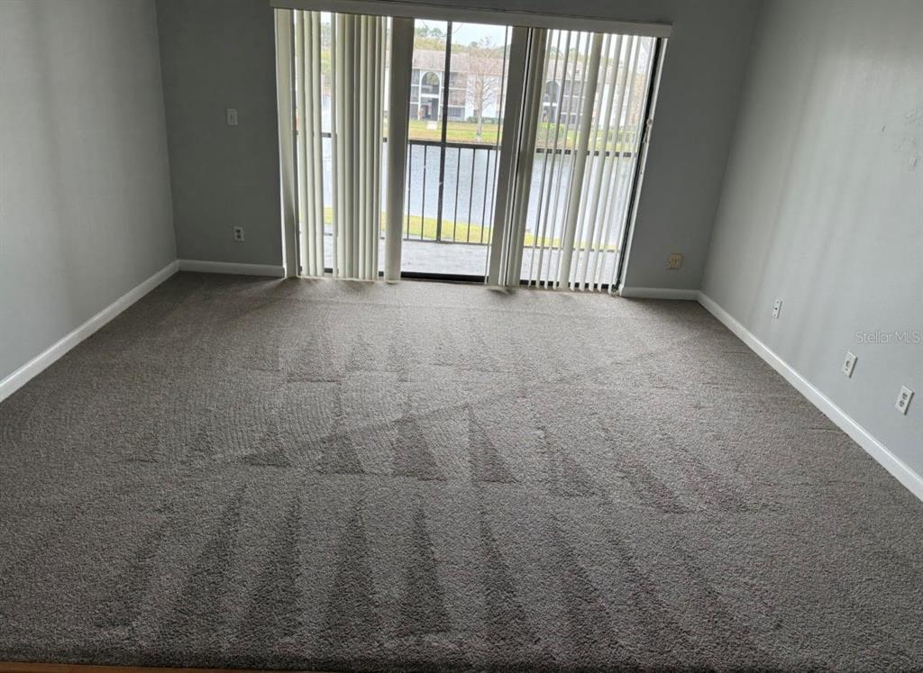 8215 Sun Spring Circle, Unit 63 Orlando, FL 32825 - Photo 5 of 22 a view of an empty room with a window