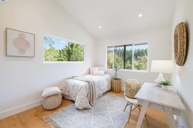 a bedroom with bed and a large window