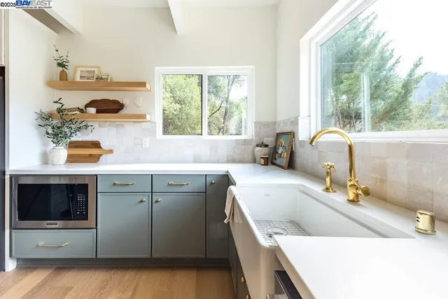 a view of a sink a mirror and a window