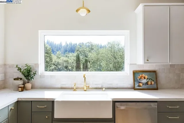 a kitchen with a sink and a large window
